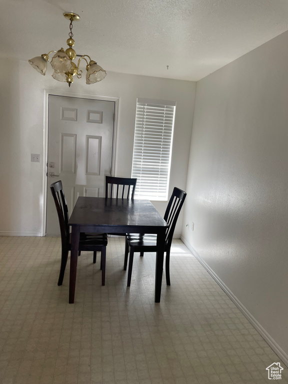 Dining area featuring a chandelier and baseboards