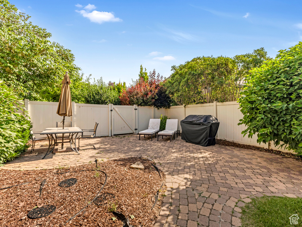 Fenced backyard with a gate and a patio