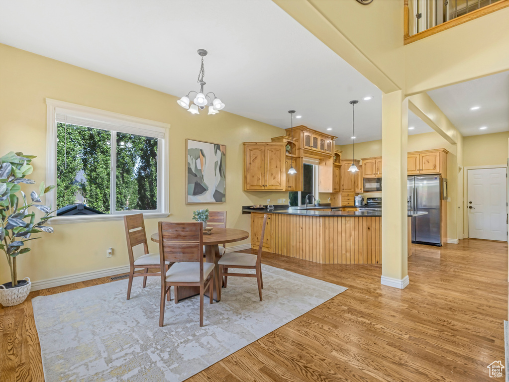Dining room featuring light wood finished floors, a chandelier, and recessed lighting