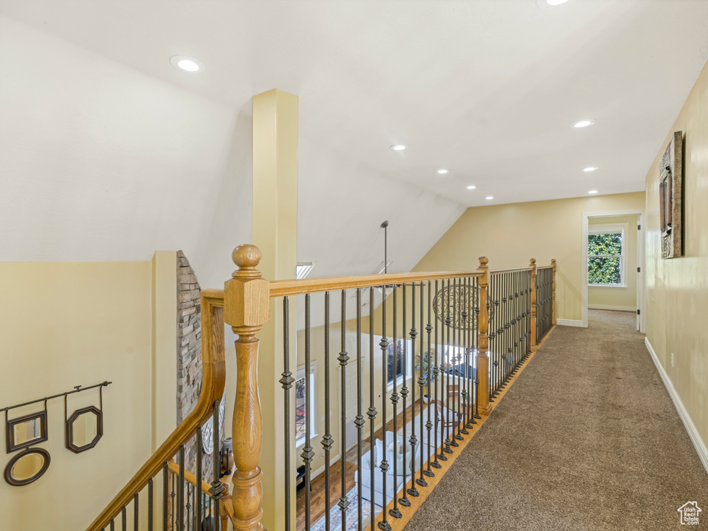 Corridor with recessed lighting, vaulted ceiling, carpet flooring, and an upstairs landing