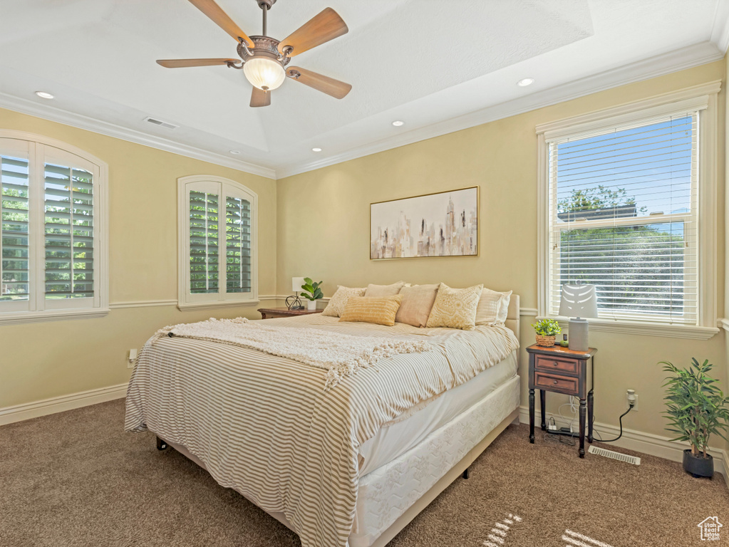 Carpeted bedroom featuring multiple windows, ornamental molding, recessed lighting, and ceiling fan