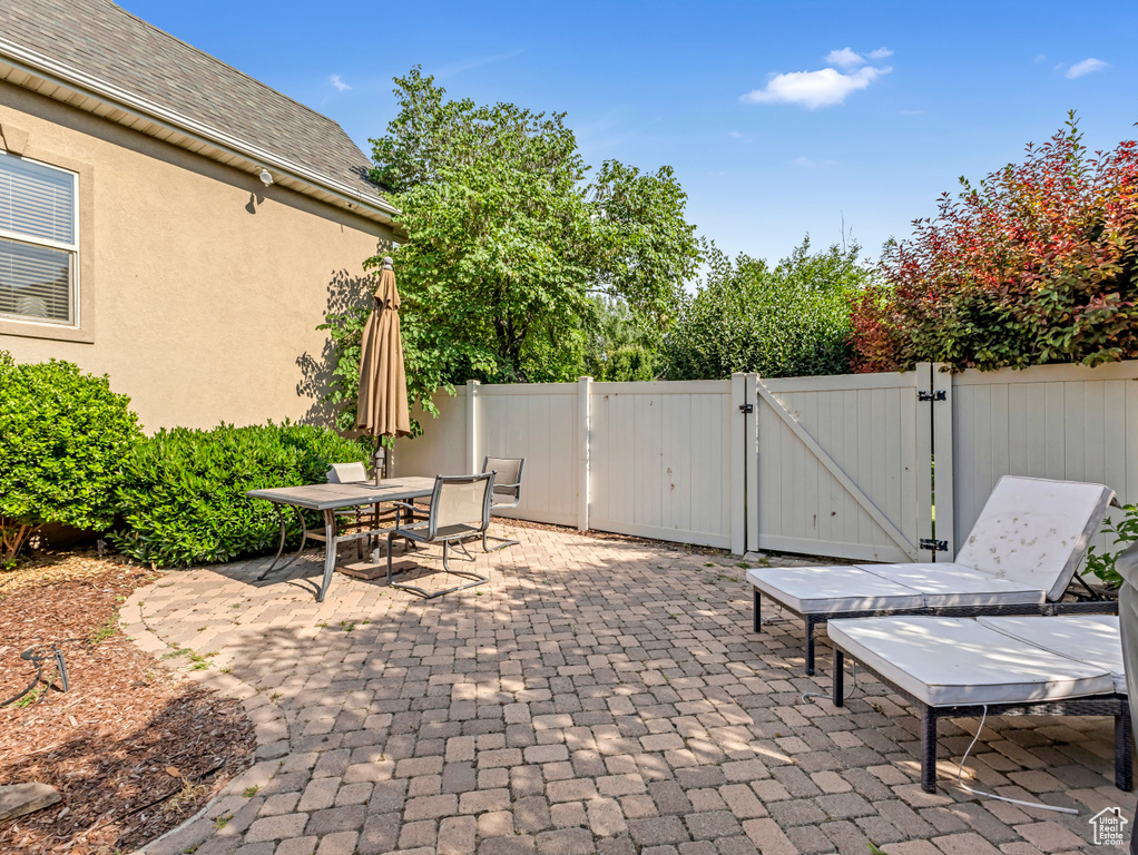 View of patio / terrace featuring a gate and outdoor dining area