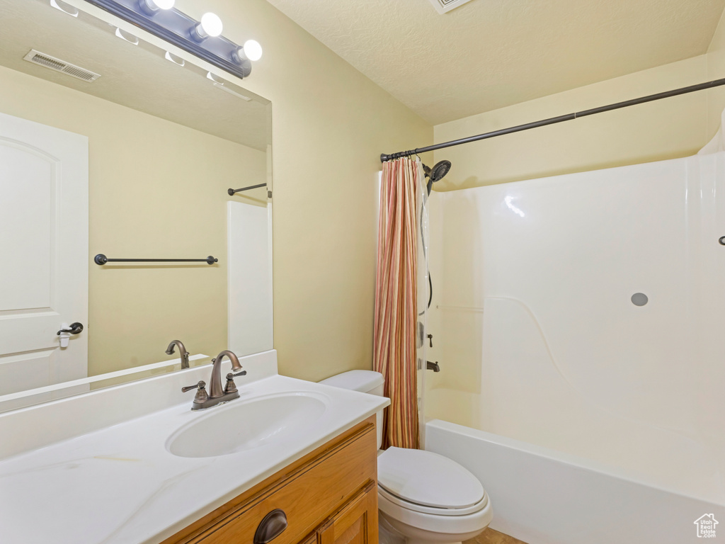 Full bath featuring vanity and shower / tub combo with curtain