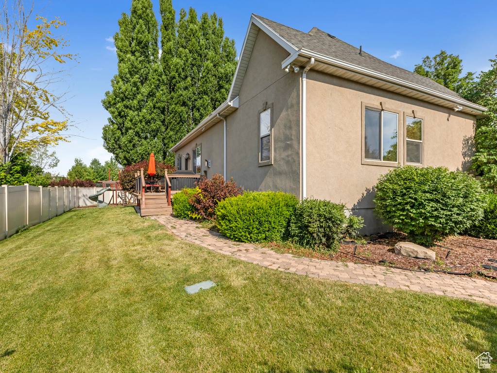 View of home\\\'s exterior featuring stucco siding and a deck