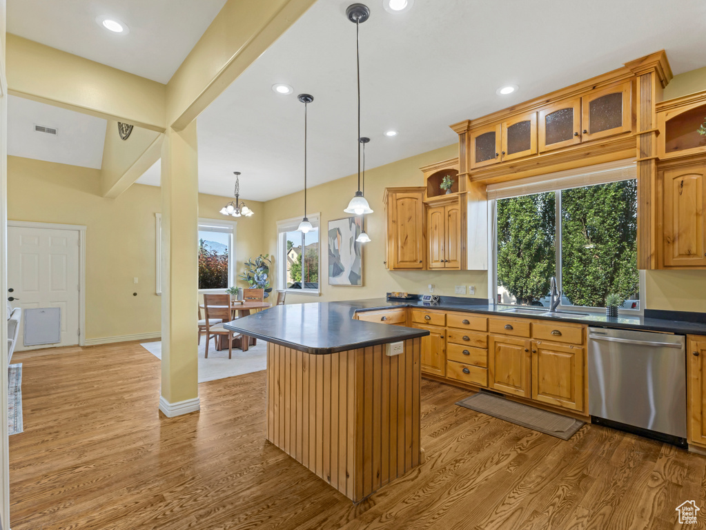 Kitchen with dishwasher, dark countertops, wood finished floors, glass insert cabinets, and recessed lighting
