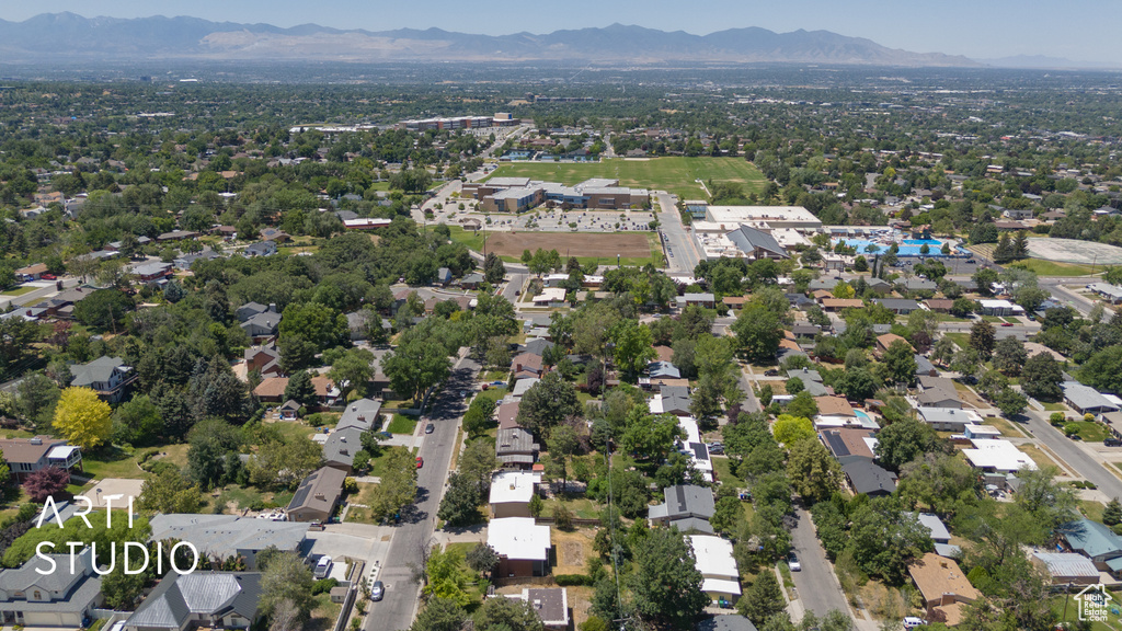 Aerial view of property's location featuring a mountainous background and nearby suburban area