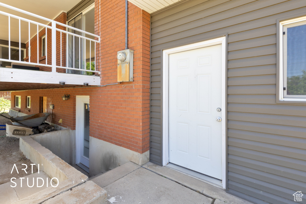 Entrance to property featuring brick siding