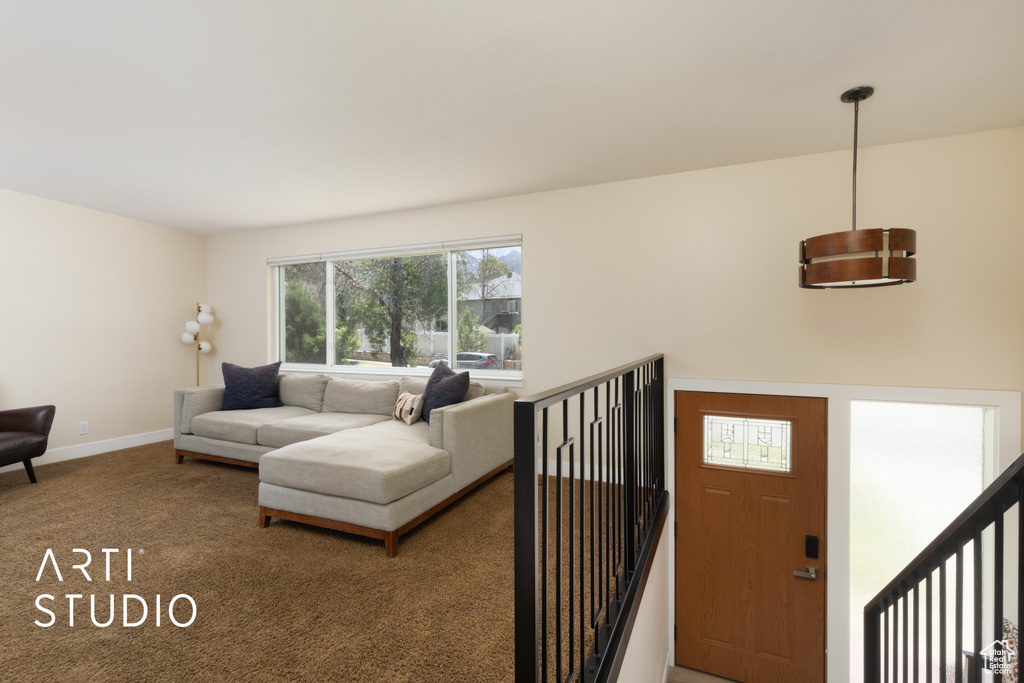 Carpeted living area with baseboards