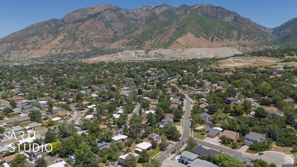 Aerial view of property's location with mountains and nearby suburban area