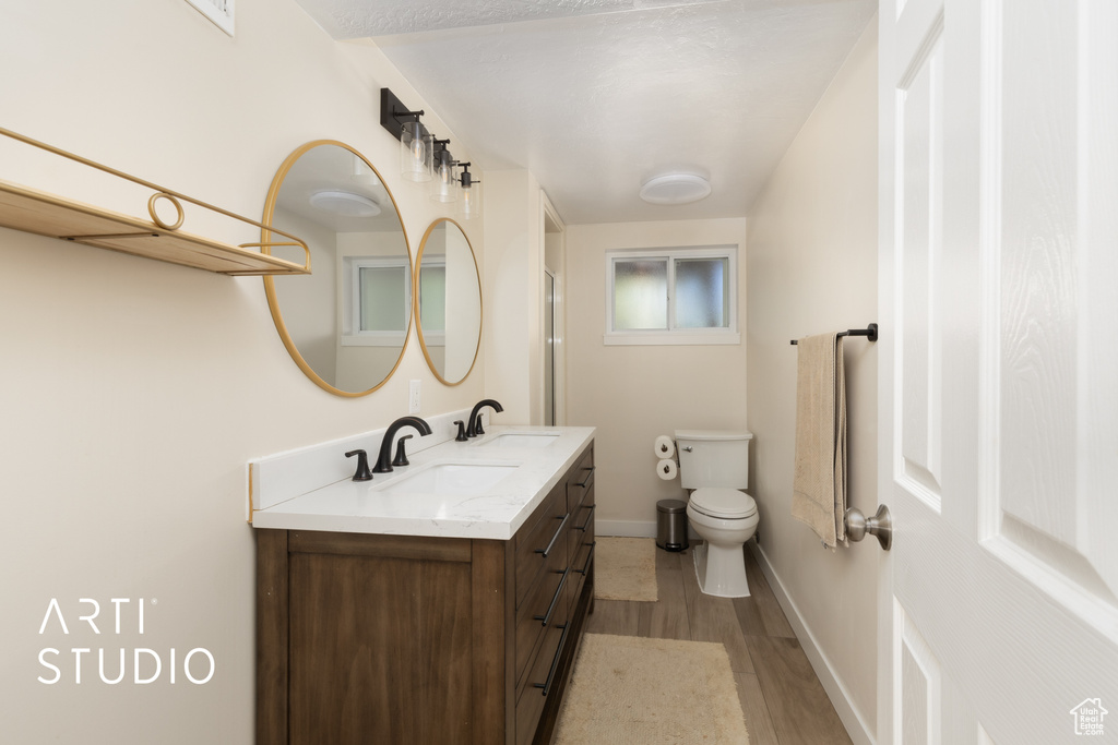 Full bathroom with wood finished floors and vanity