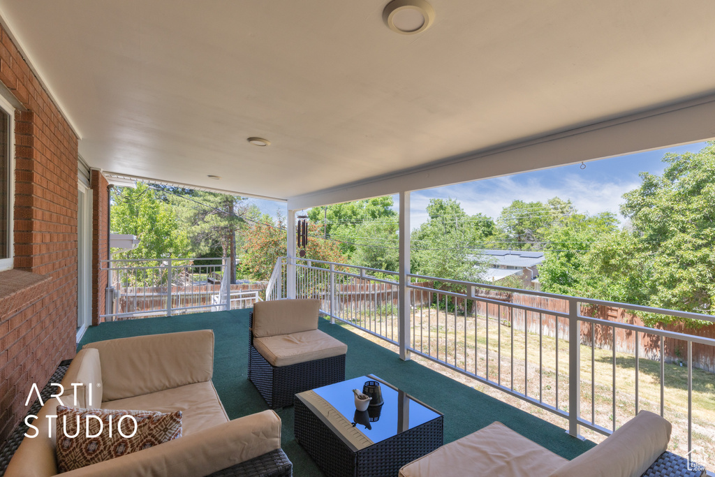 Patio / terrace with outdoor lounge area and view of wooded area