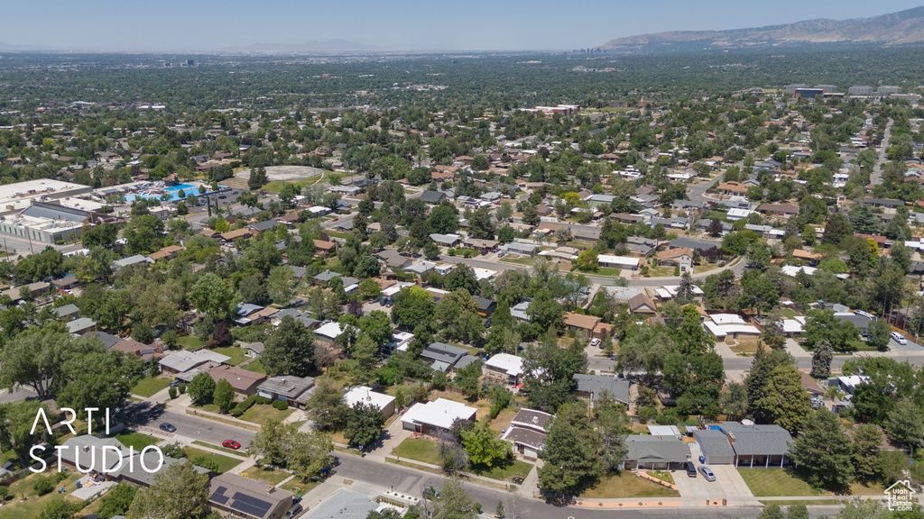 Aerial view of property and surrounding area featuring mountains