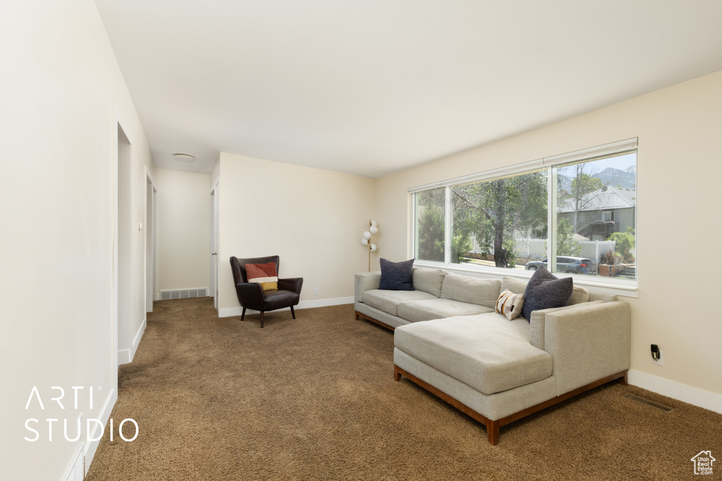 Carpeted living room featuring baseboards