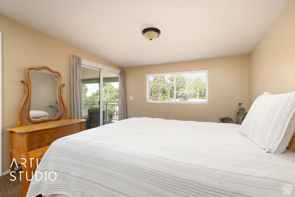 Bedroom featuring access to exterior and carpet flooring