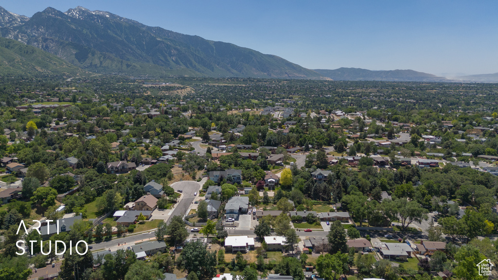 Aerial perspective of suburban area featuring a mountainous background