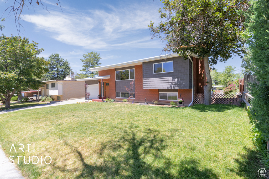 View of front of home featuring concrete driveway, an attached garage, and brick siding