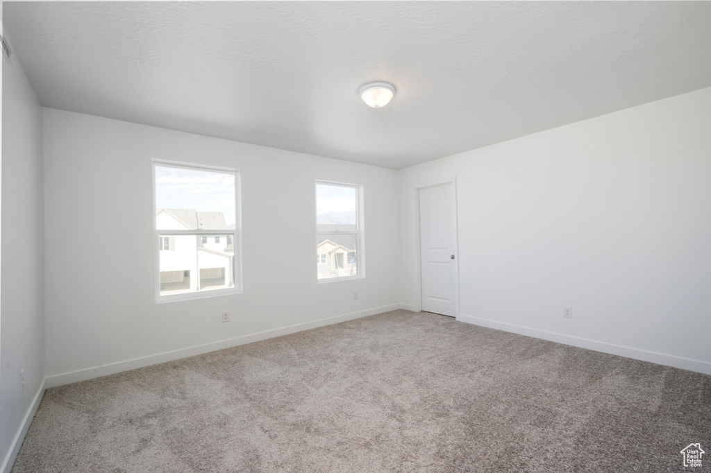 Spare room with carpet floors and baseboards