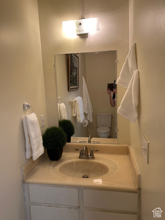 Half bath with vanity and toilet