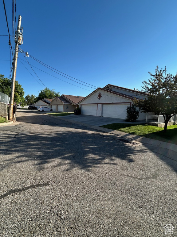 View of front facade featuring driveway and a garage