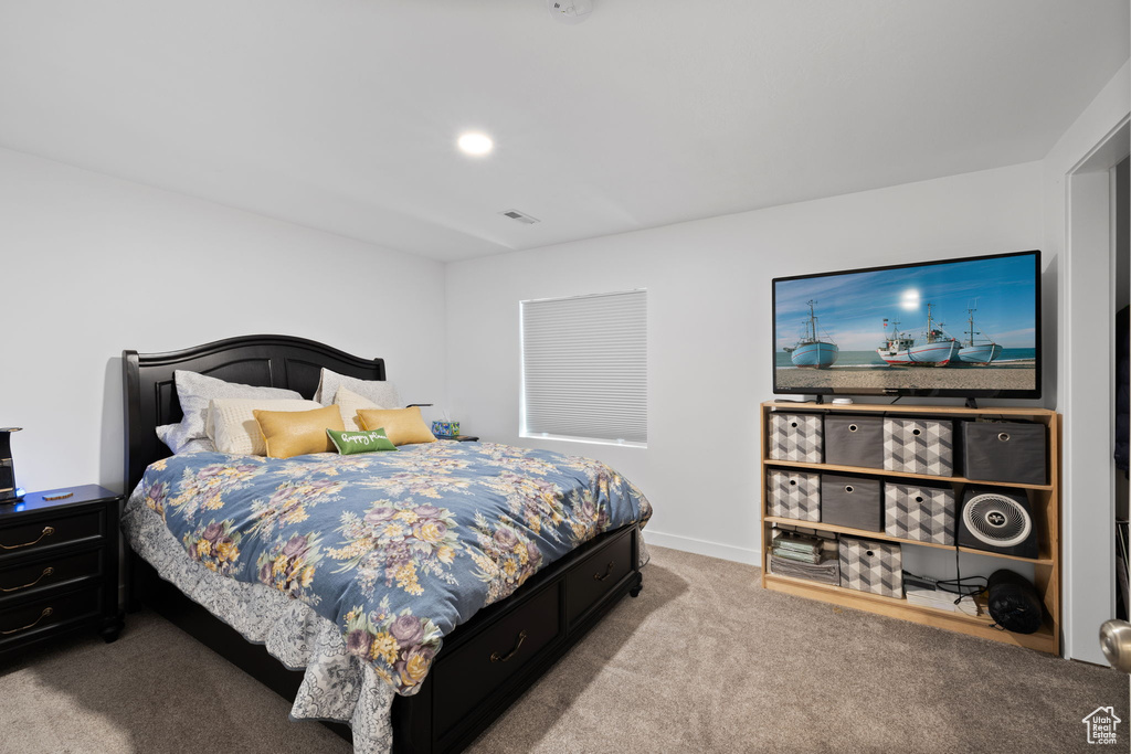 Carpeted bedroom with baseboards
