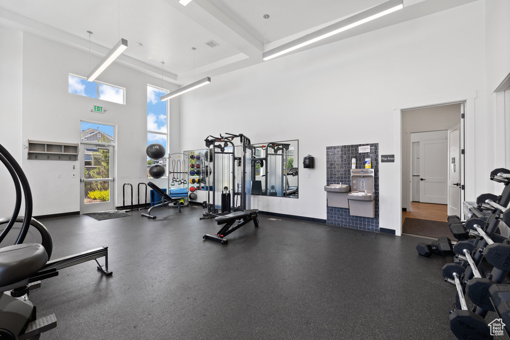 Workout area featuring a towering ceiling