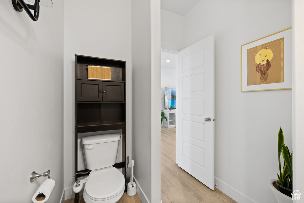 Bathroom with wood finished floors and toilet