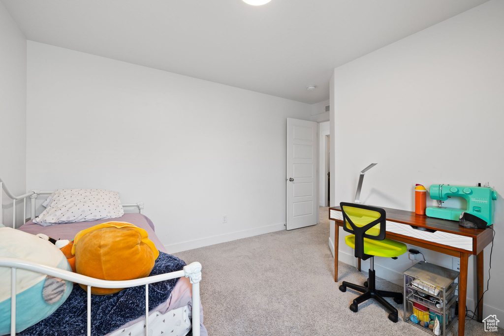 Bedroom featuring carpet floors and baseboards