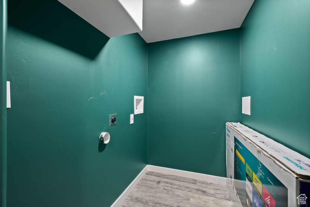Washroom with wood finished floors, electric dryer hookup, and washer hookup