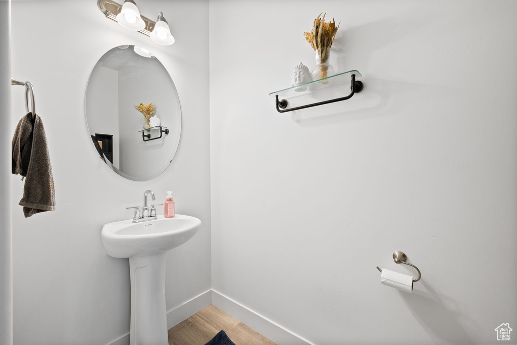 Bathroom featuring wood finished floors and baseboards