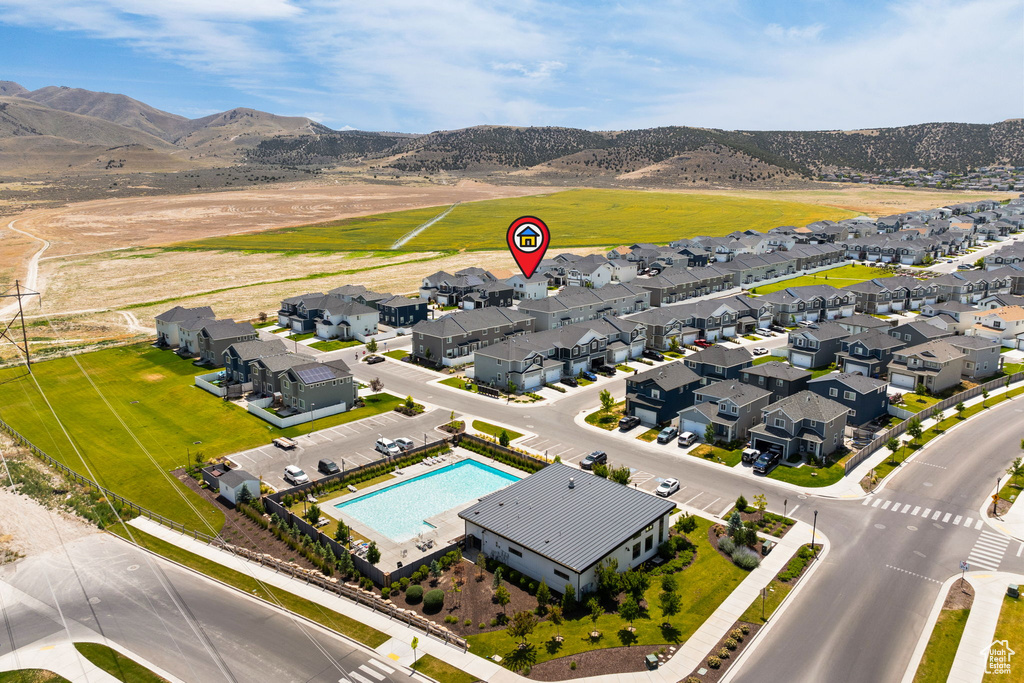 Aerial view of residential area with mountains and a pool