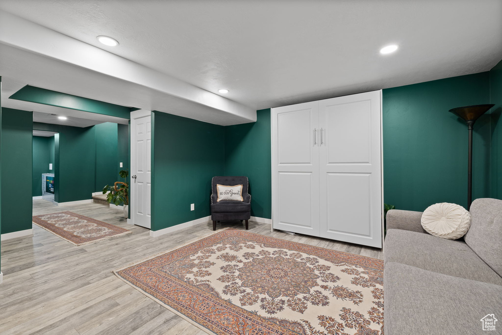 Sitting room with light wood-type flooring and recessed lighting