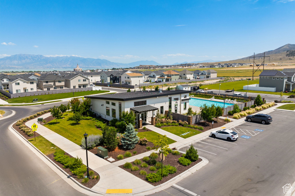 Aerial view of residential area with a mountainous background and a pool area