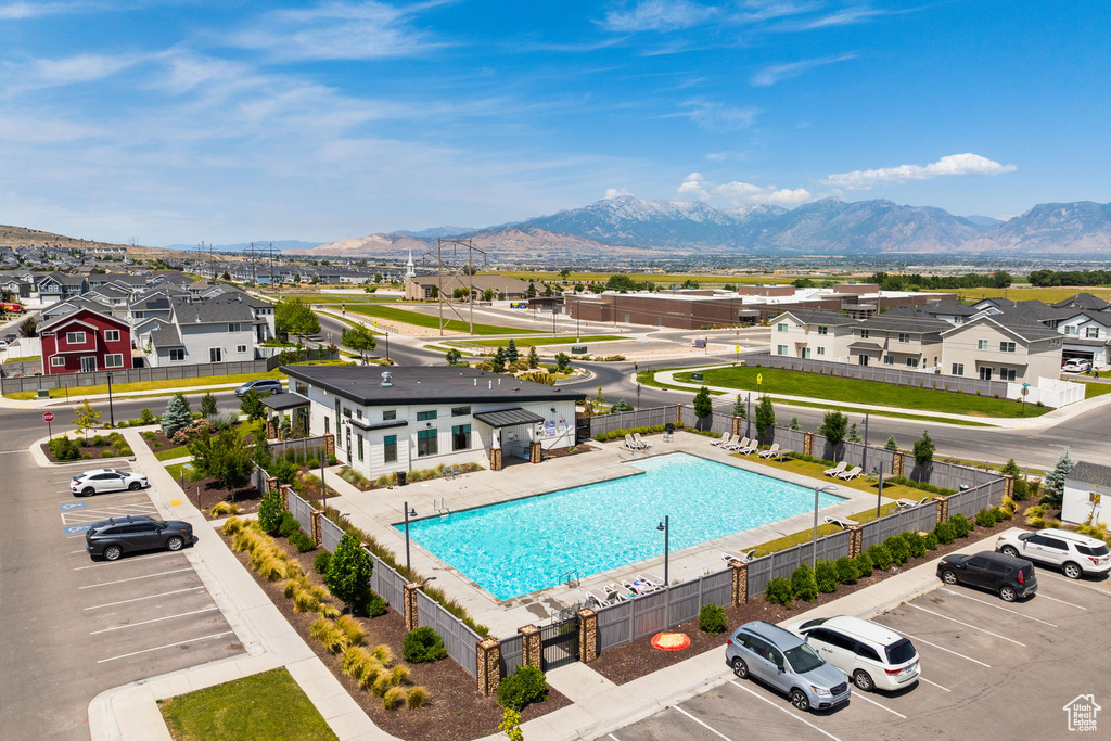 Community pool with a mountain view and a residential view