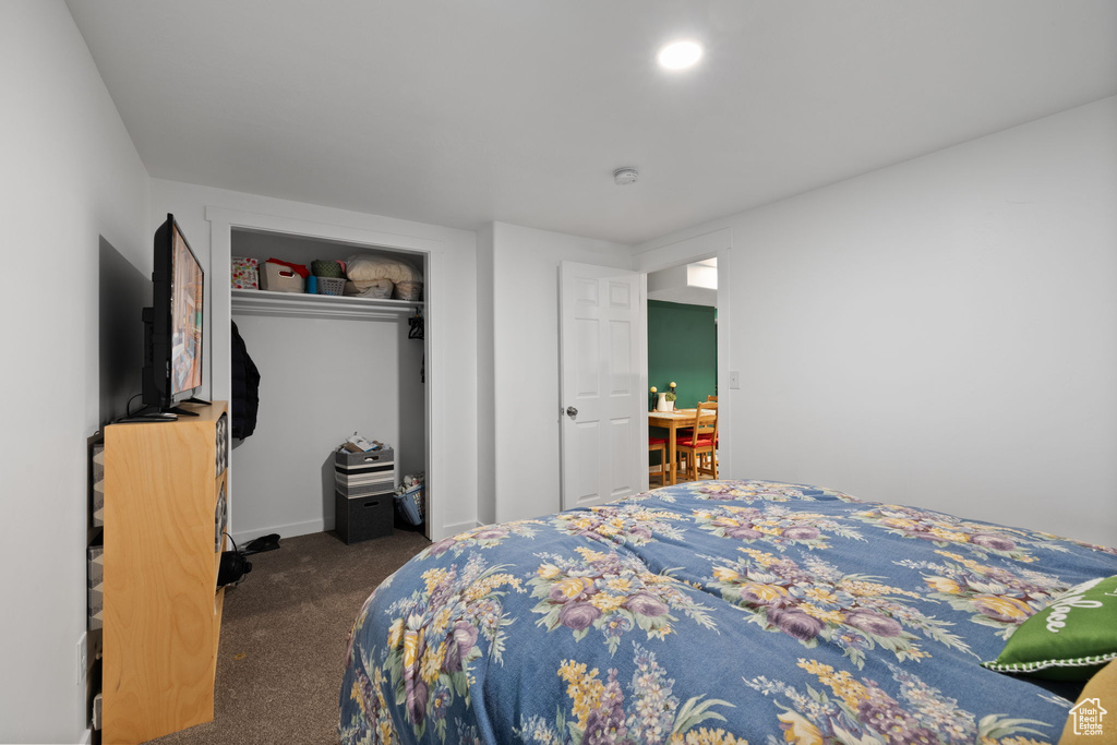 Carpeted bedroom featuring a closet and baseboards