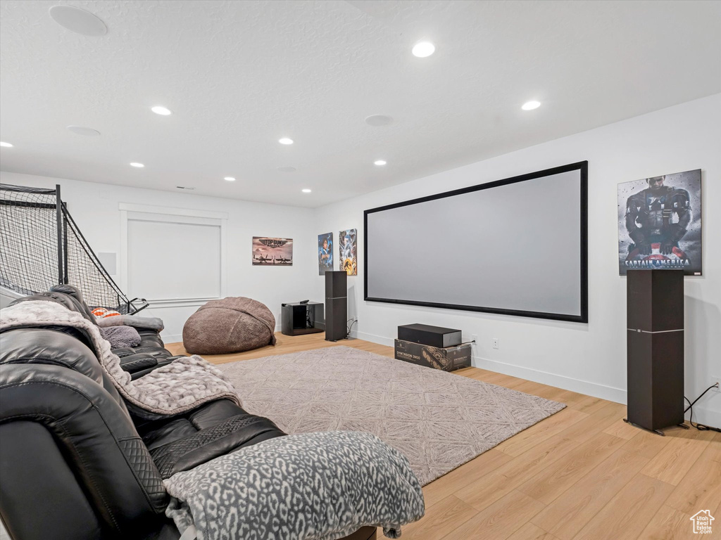 Cinema room featuring light wood-type flooring and recessed lighting