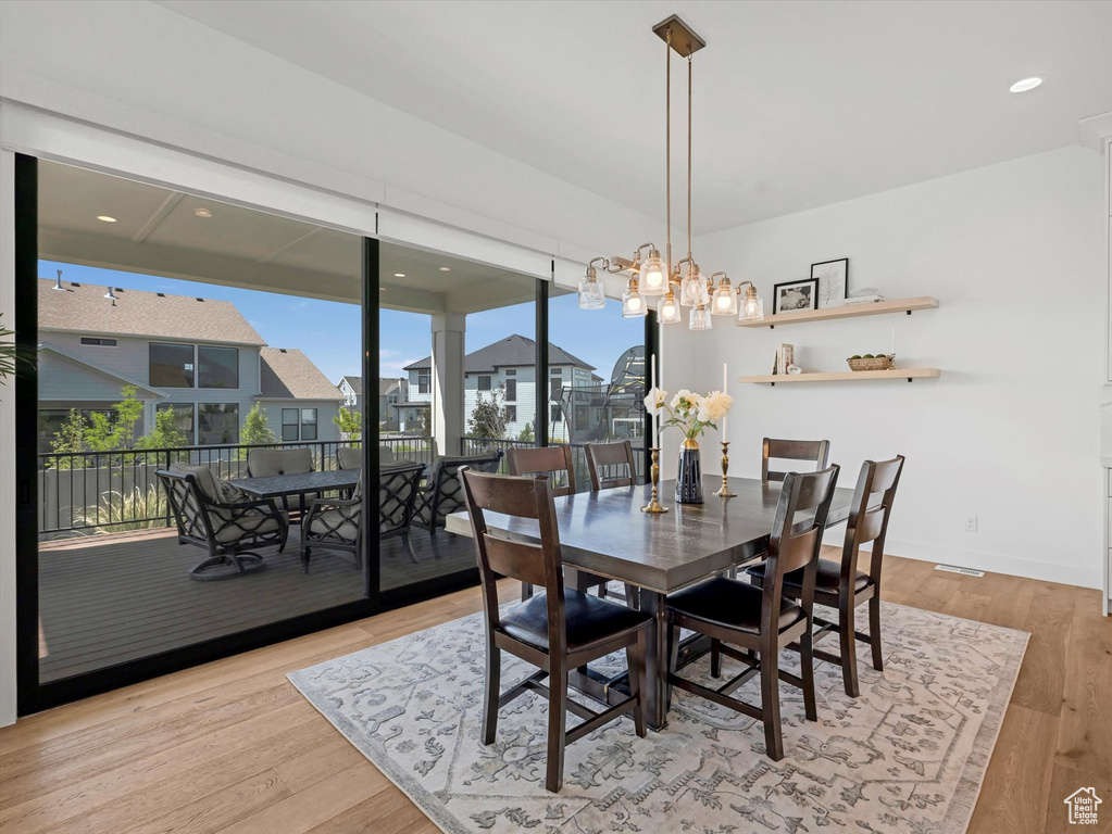 Dining room featuring wood finished floors and a chandelier