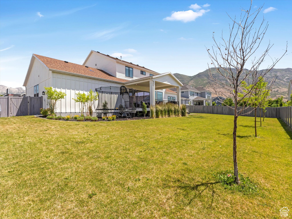 Fenced backyard with a mountain view