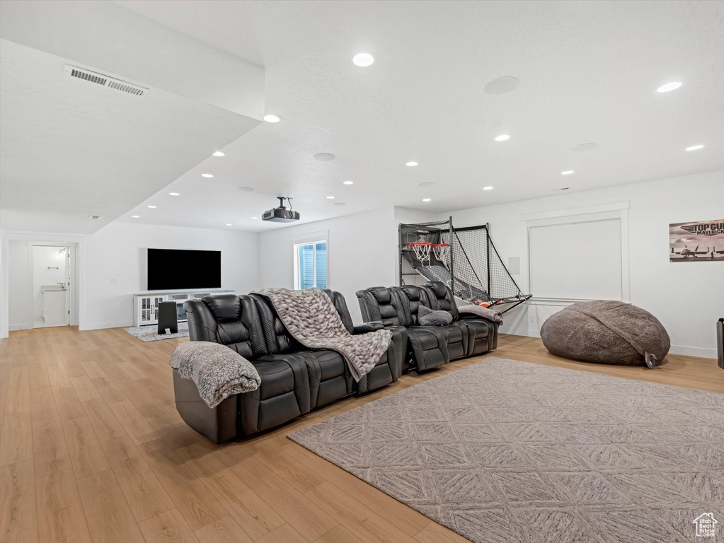 Living room featuring light wood-type flooring and recessed lighting
