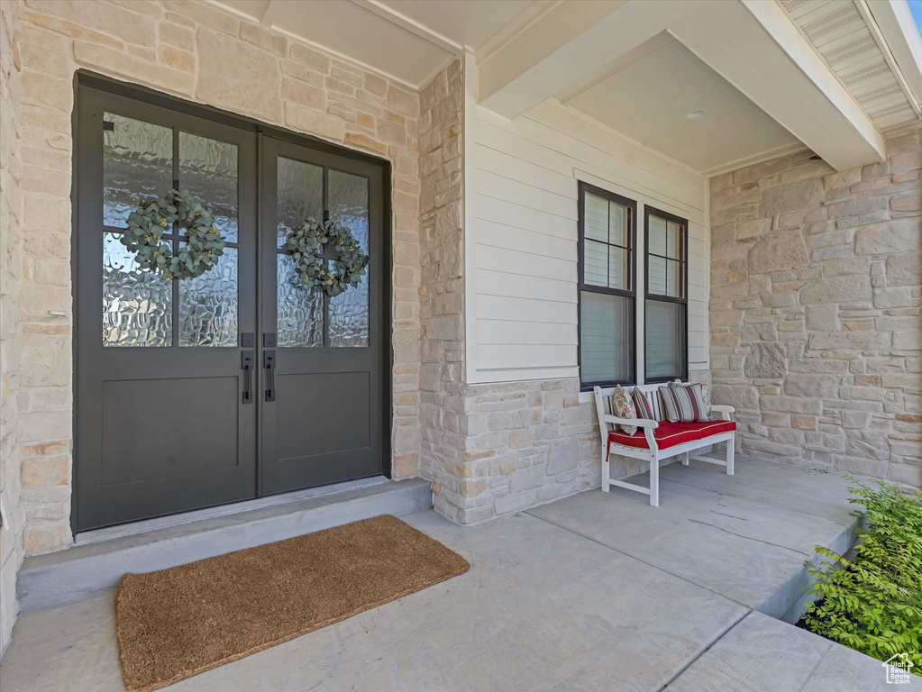 Doorway to property with french doors and stone siding