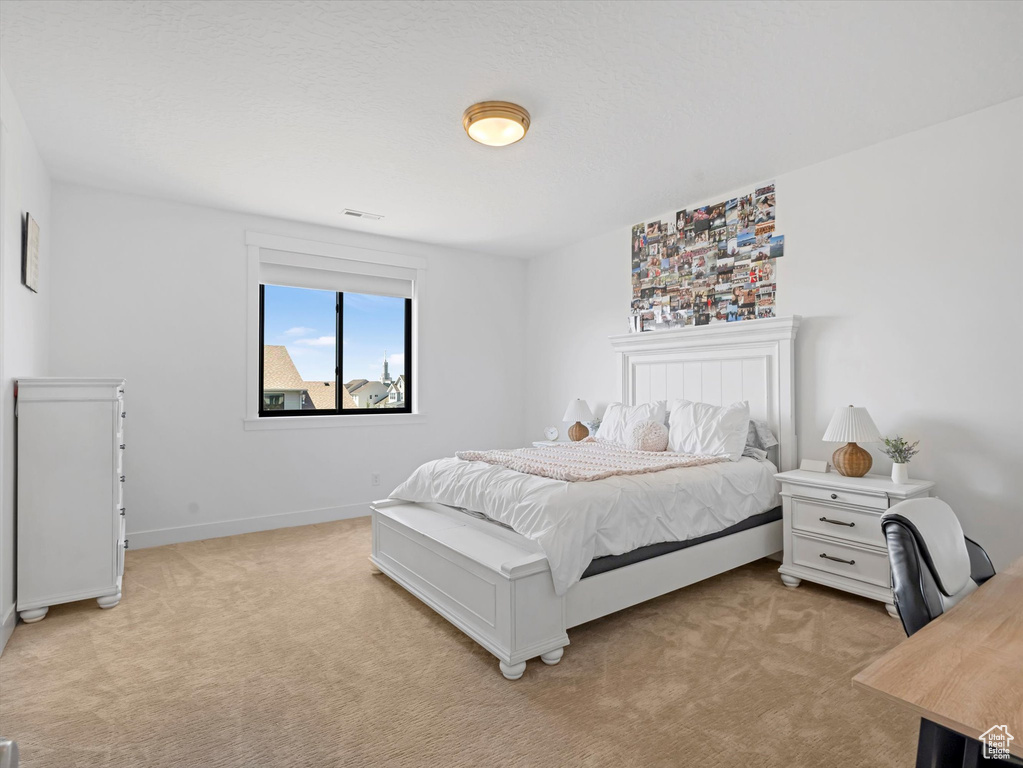 Bedroom with light carpet