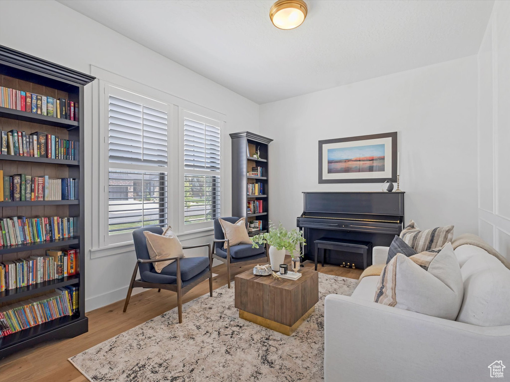 Living area with wood finished floors and baseboards
