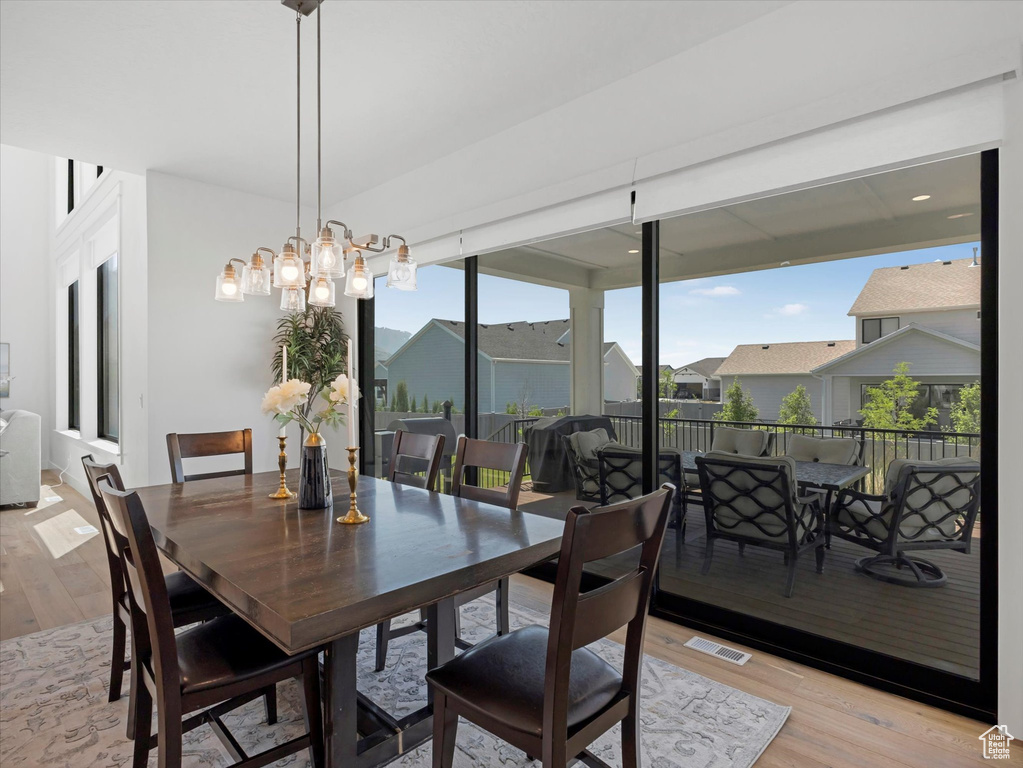Dining space featuring light wood finished floors and a residential view