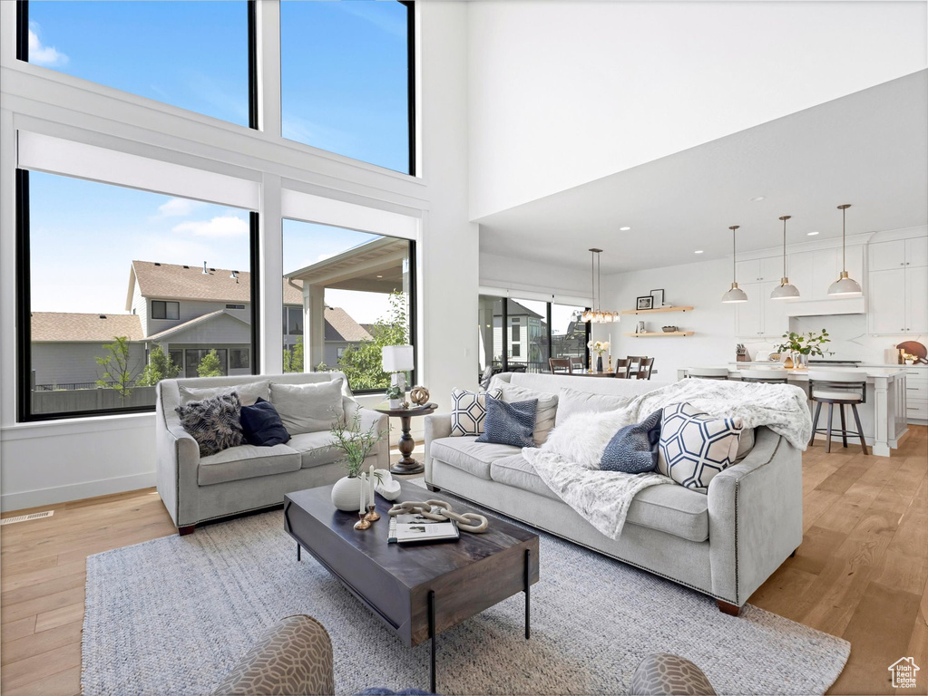 Living room featuring light wood-style flooring and recessed lighting