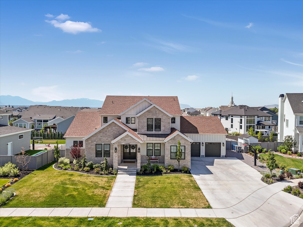 View of front of home with a residential view, board and batten siding, an attached garage, and a shingled roof