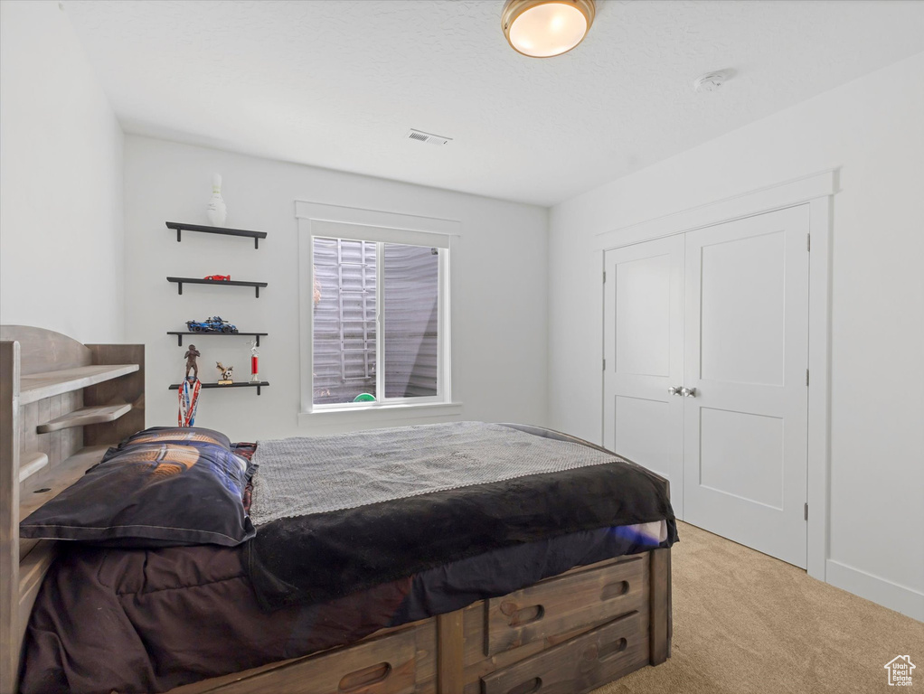 Bedroom featuring carpet floors and a closet