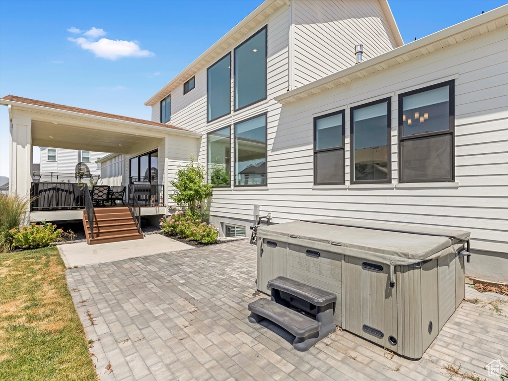 View of patio featuring a hot tub and a wooden deck