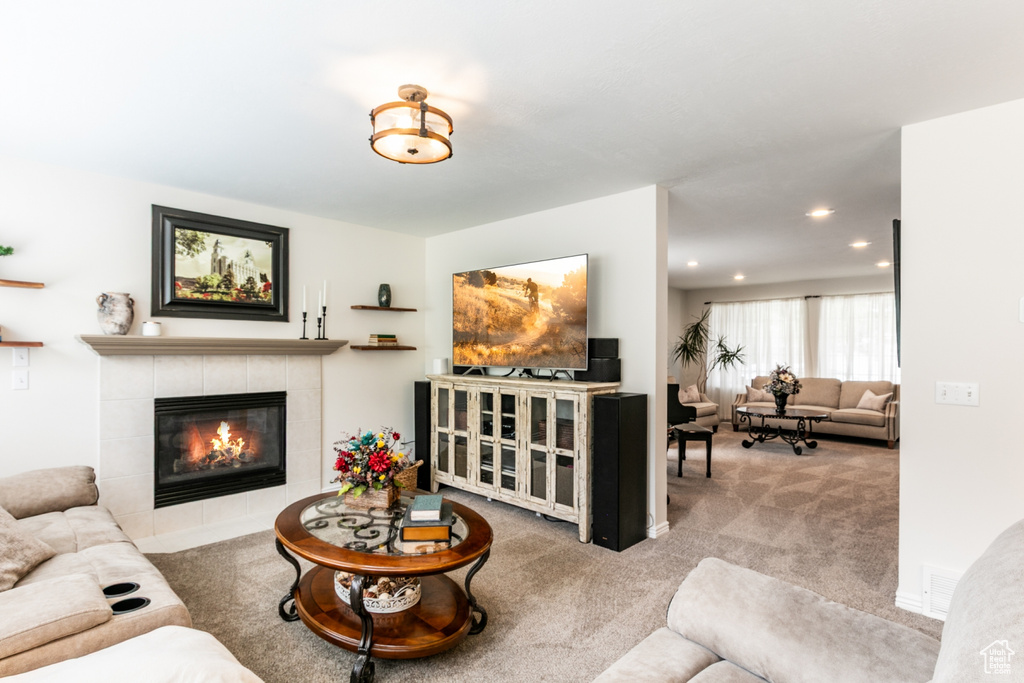Living area featuring carpet, a fireplace, and recessed lighting