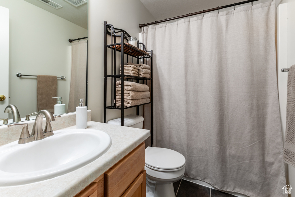 Bathroom featuring vanity and curtained shower