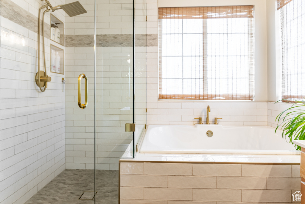 Full bath featuring a shower stall and a bath
