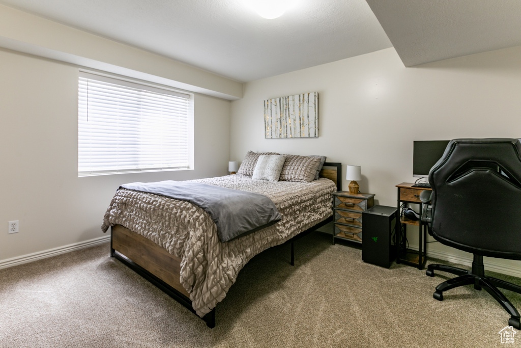 Bedroom featuring carpet flooring and baseboards